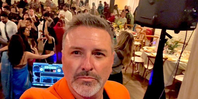 Dynamic hybrid entertainment experience with DJ, emcee, and game show host engaging an audience